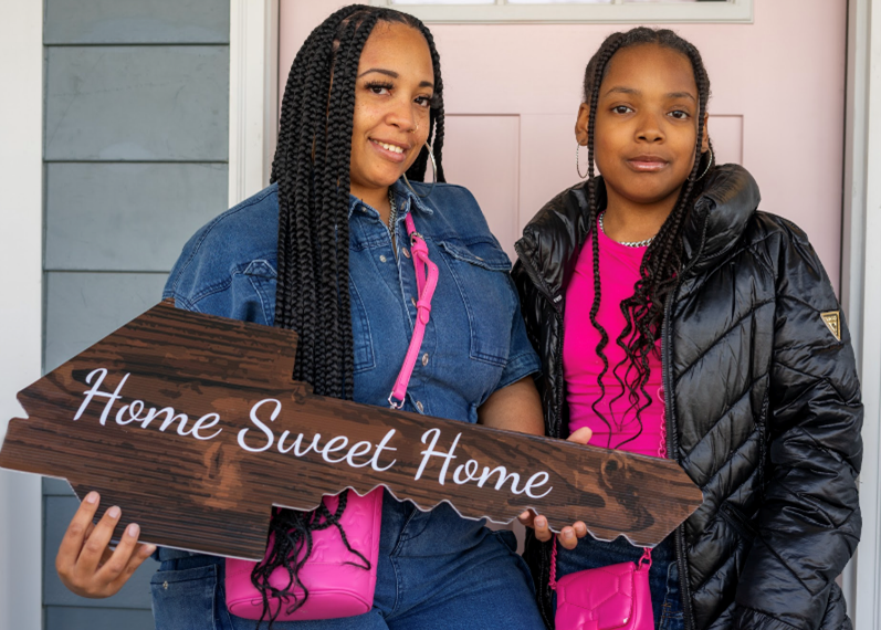 Ceairra Lipscomb and her daughter outside of their new home.
