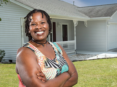 Denise Franklin smiles in front of her new home